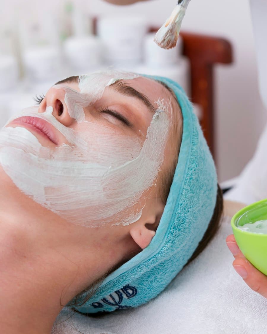 Client receiving a relaxing facial treatment with a warm towel wrap at Aurelle Skin Clinic