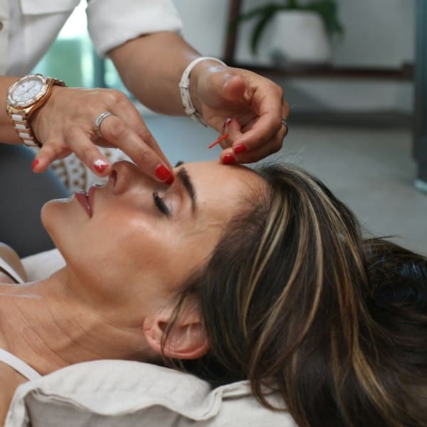Close-up of an esthetician's hands during a precise skincare consultation